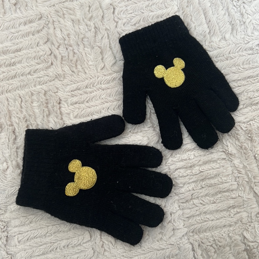 Black stretch knit gloves with gold color embroidered Mickey Mouse
One size
